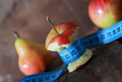 Image of a mostly eaten apple with a measuring tape around the middle, illustrating that eating disorders can be treated through therapy, medication, or a combination of both.