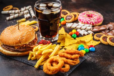 Image of a large variety of junk foods, illustrating that Bulimia Nervosa involves bingeing on large quantities of food in a short time followed by purging.