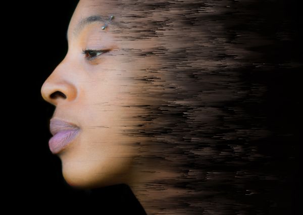 Stylized image of a young woman of color fading into the background, illustrating the concept that there are therapeutic approaches that can help manage Borderline Personality Disorder.